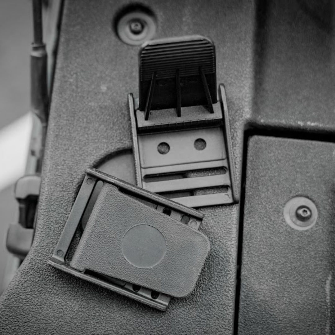 Two black plastic quick-release mounting clip